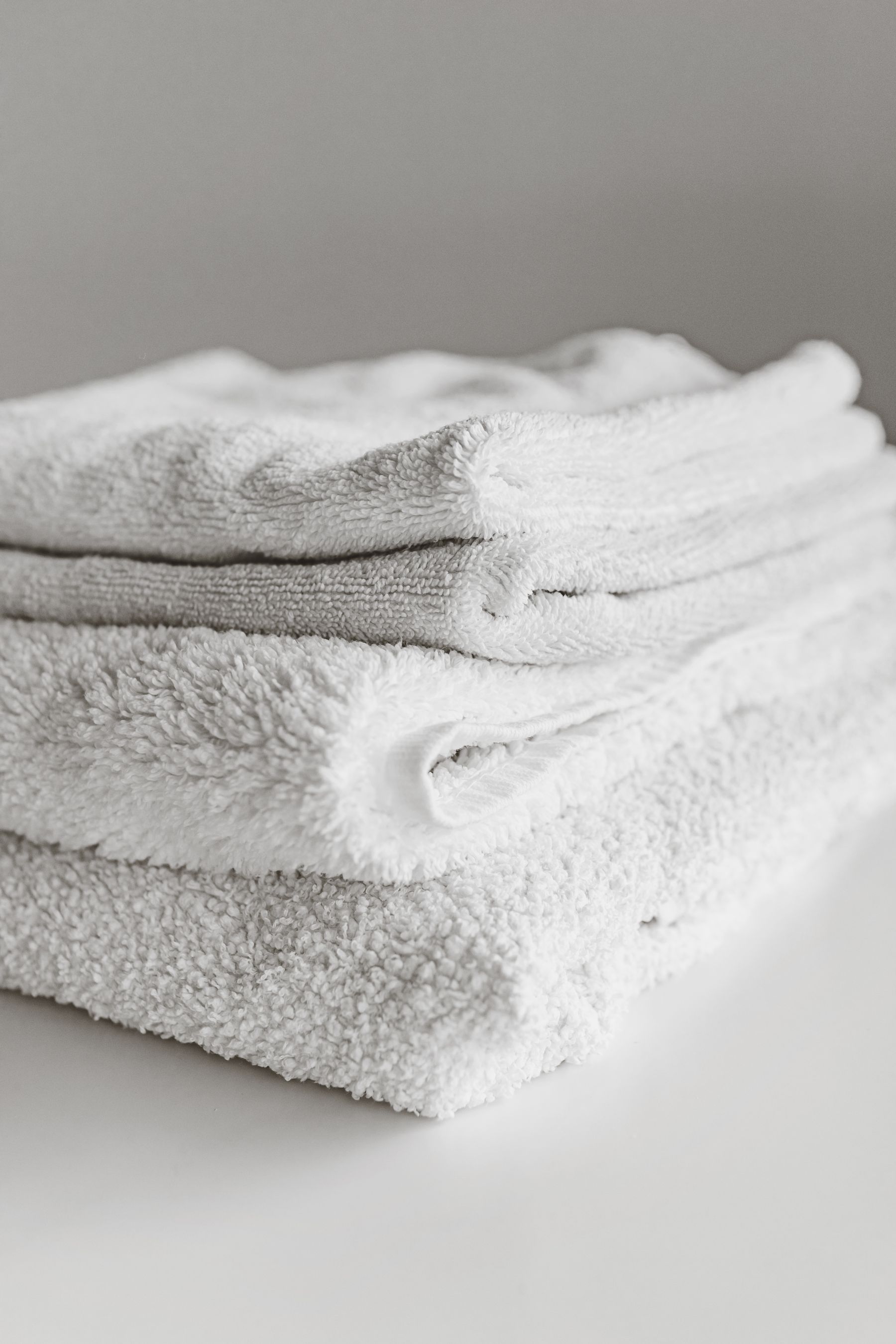Freshly folded clean white towels ready for wash and fold return